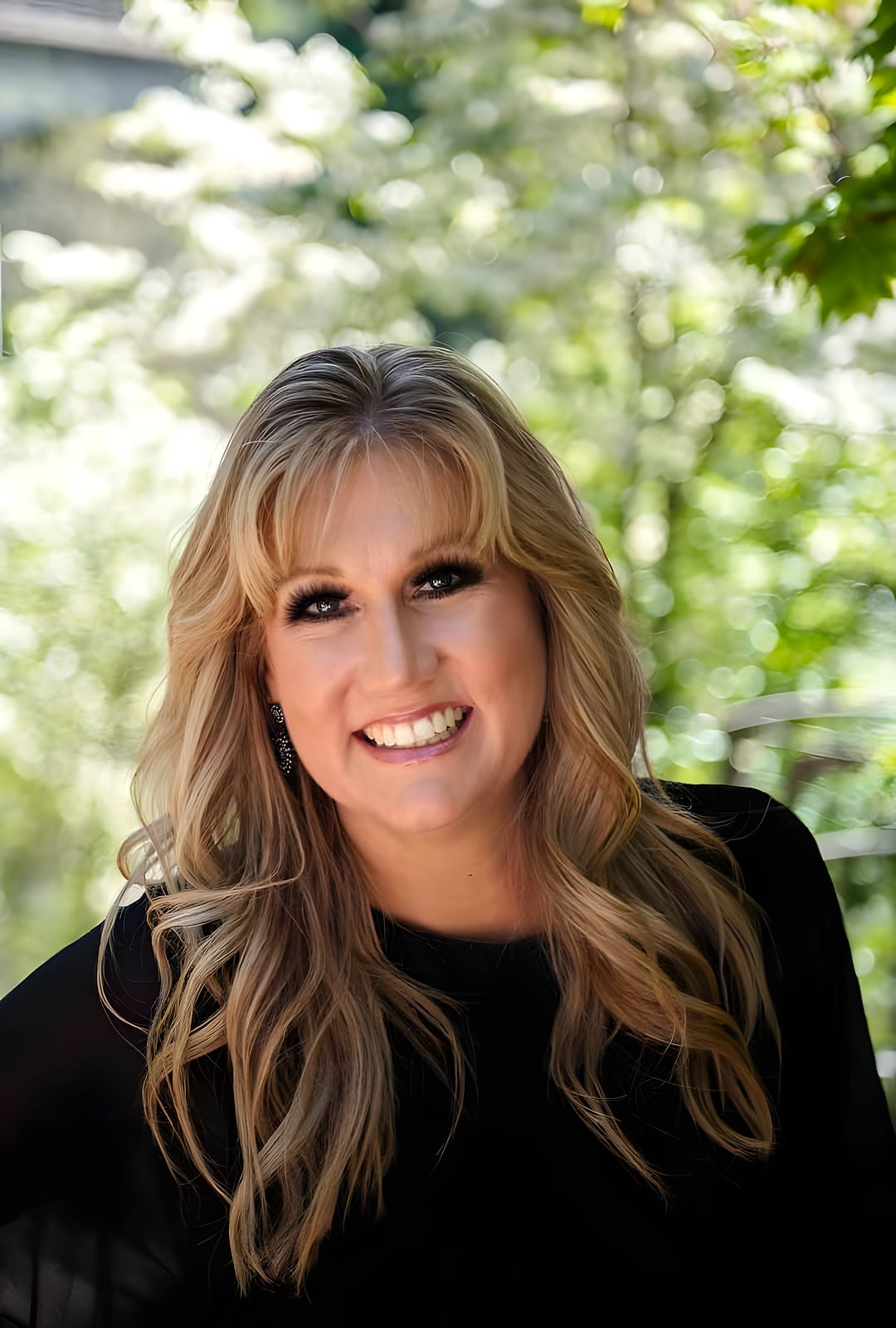 A Salon Sister with blonde hair and bangs